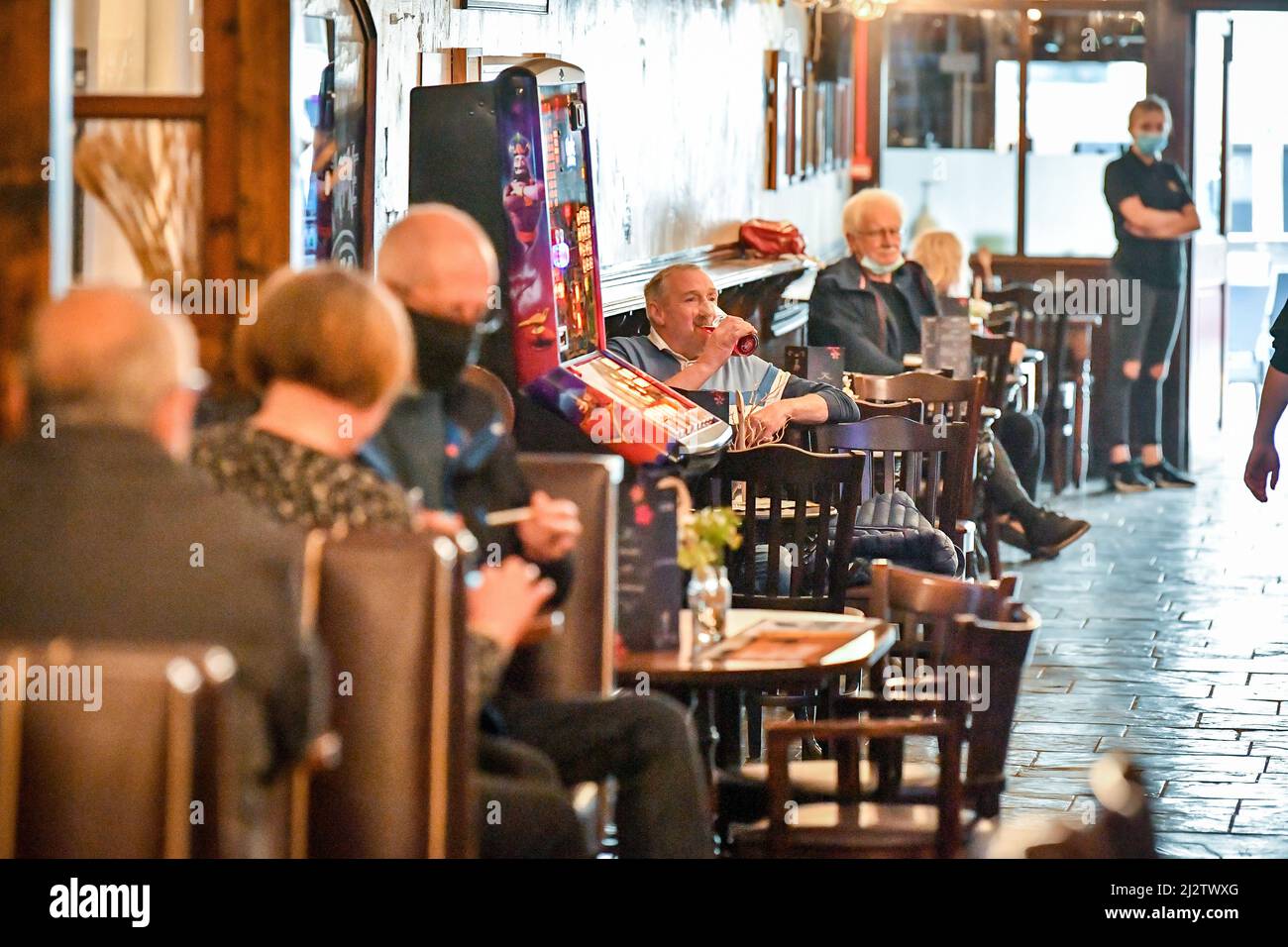 File photo dated 17/05/21 of customers inside The Borough pub on St Mary's Street, Cardiff, as indoor hospitality and entertainment venues reopened to the public. Altus Group's analysis of official government data shows that hospitality firms in England affected by Omicron have received less than half of the £635 million support package promised by the Government. Issue date: Monday April 4, 2022. Stock Photo