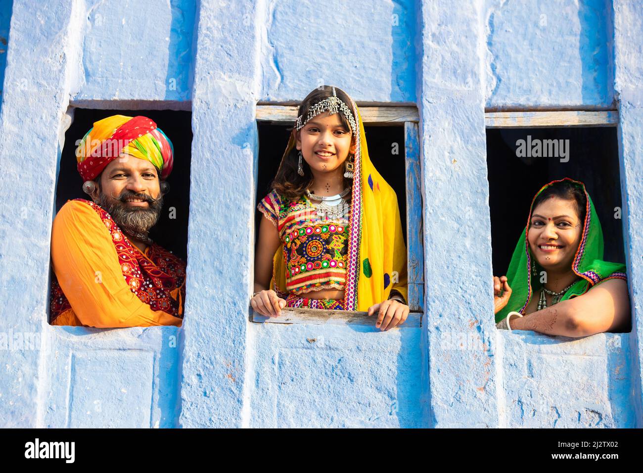 Happy indian traditional family wearing traditional colorful rajasthan ...