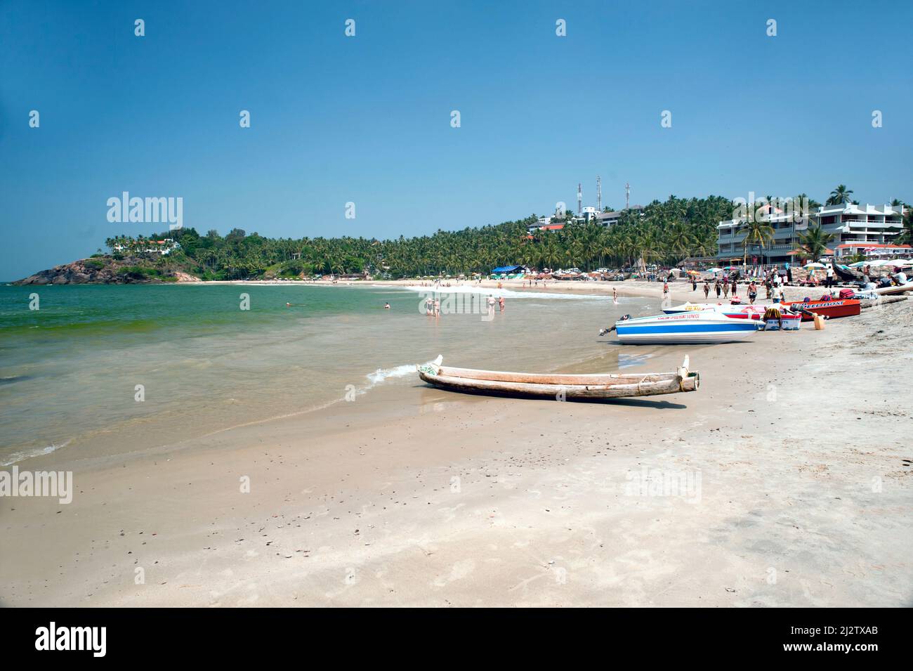 Traditional fishing boat and modern boats parked on Kollam beach state ...