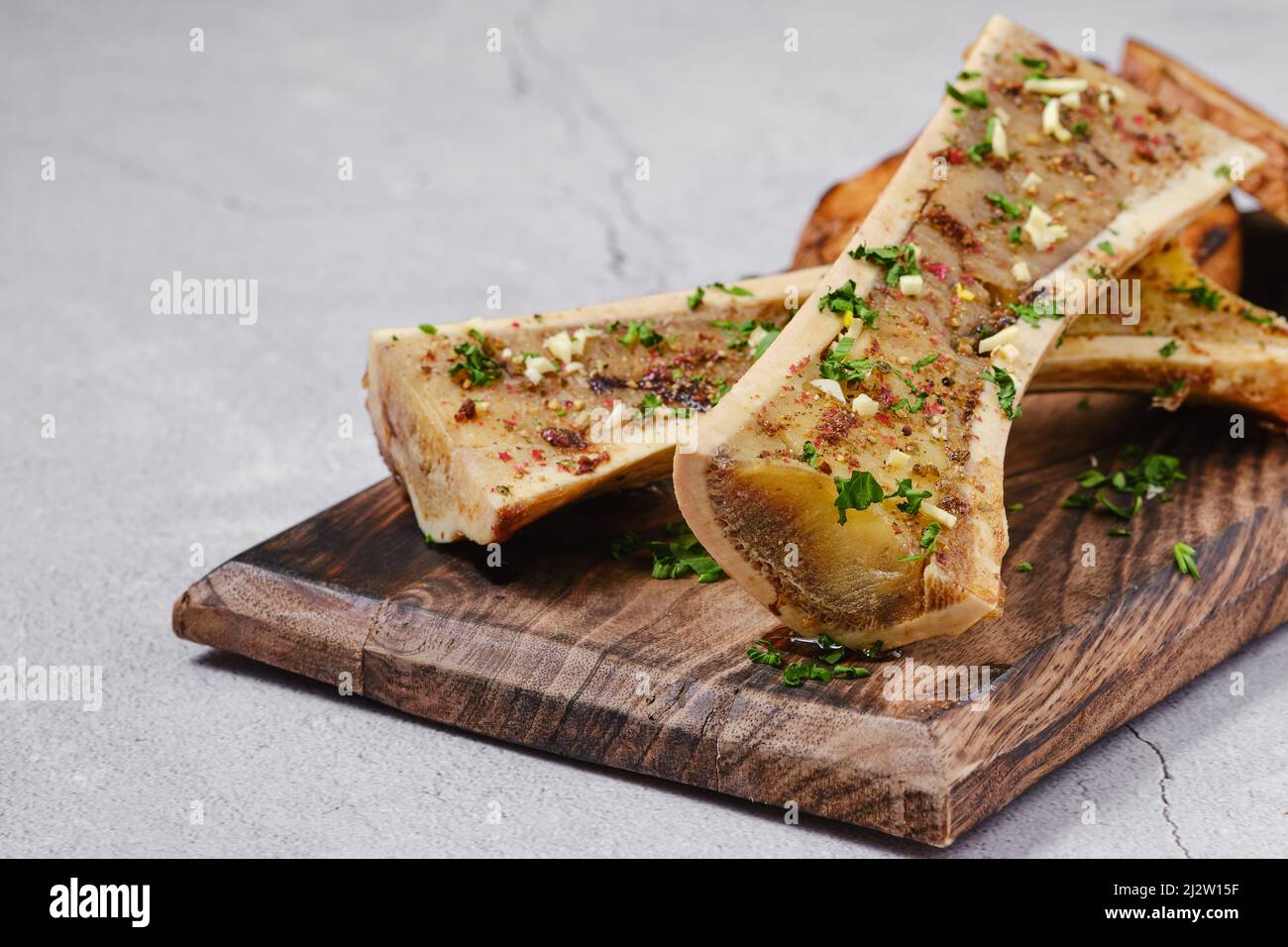 Homemade roasted beef bone marrow with garlic bread, closeup Stock