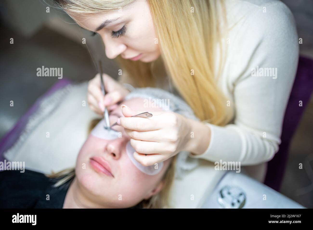 Eyelash extension procedure in beauty salon. Lashes close up. Concept