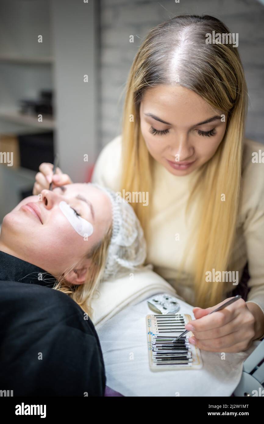 Eyelash extension procedure in beauty salon. Lashes close up. Concept
