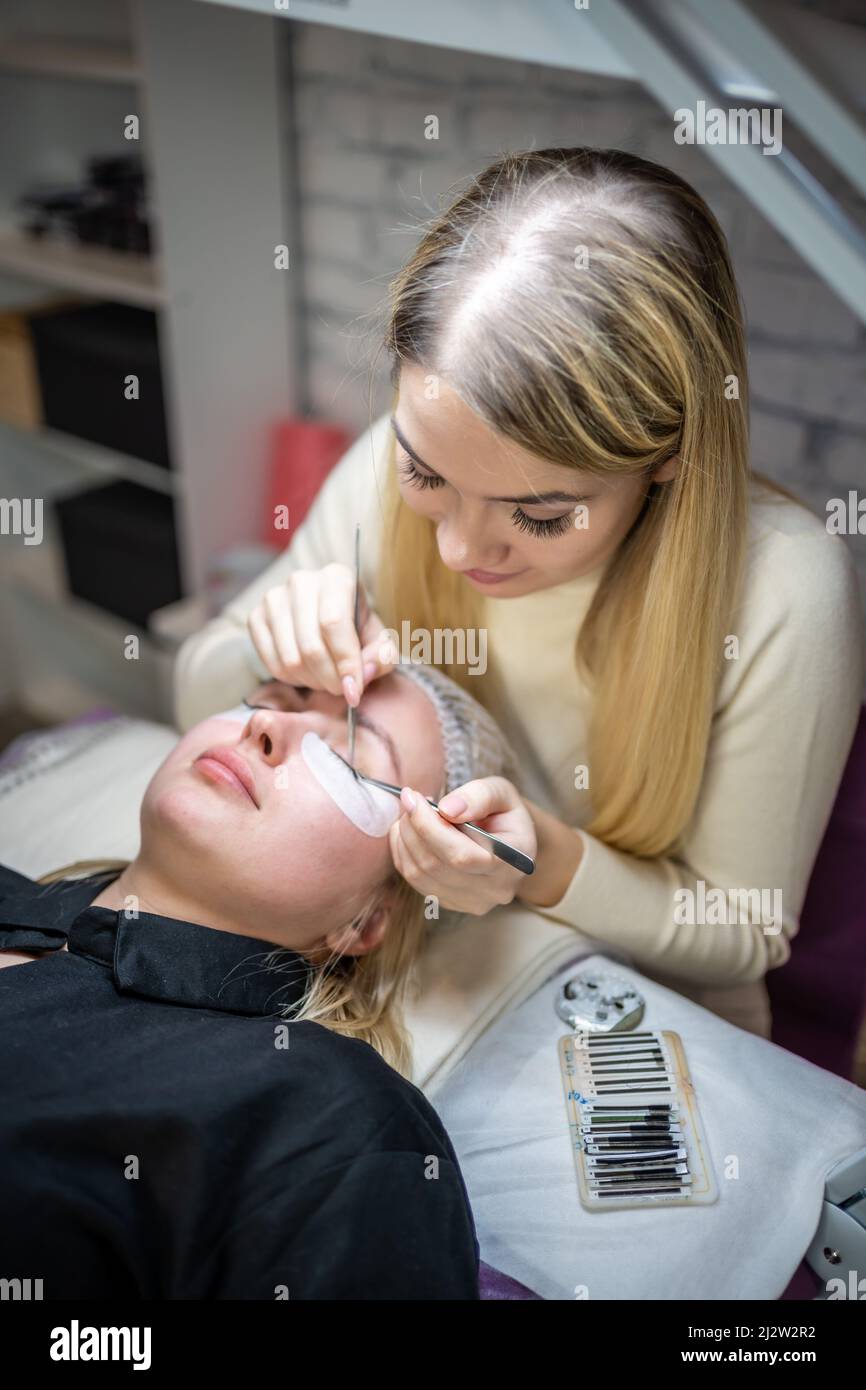 Eyelash extension procedure in beauty salon. Lashes close up. Concept spa lash.  Stock Photo