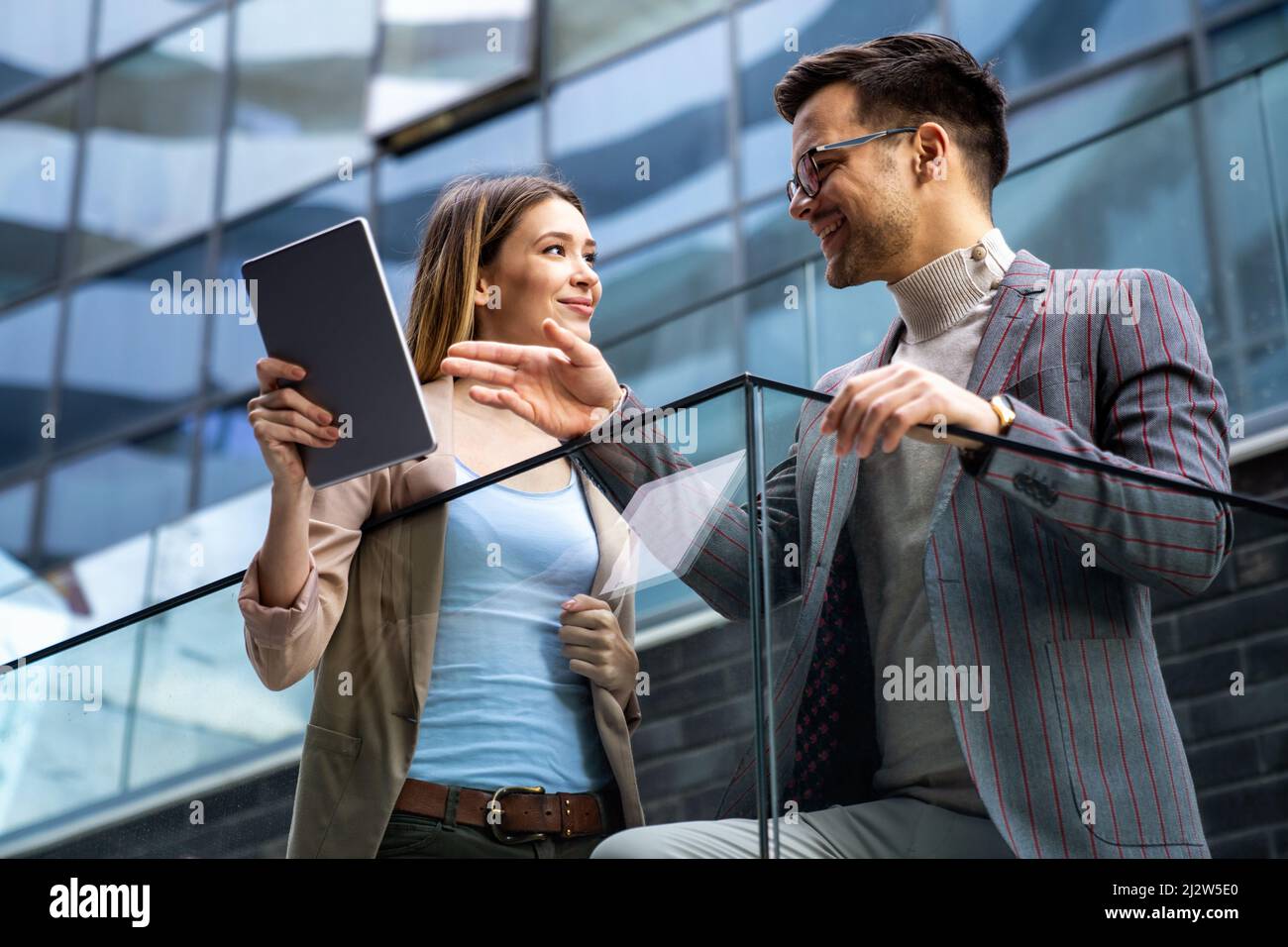 Portrait of successful business people working, talking together in urban background. Stock Photo