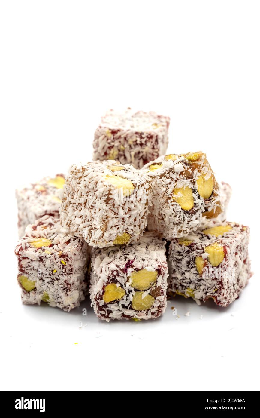 Turkish Delight with Pistachio isolated on a white background. Turkish Delight with Coconut Grain on it and Pistachio inside. Close-up. Traditional Tu Stock Photo