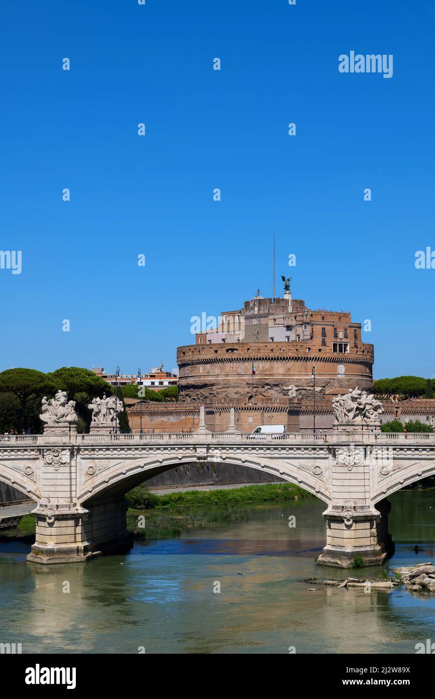 City of Rome in Italy. View to the Castel Sant Angelo (Castle of the Holy Angel) and Ponte Vittorio Emanuele II bridge on river Tiber. Stock Photo