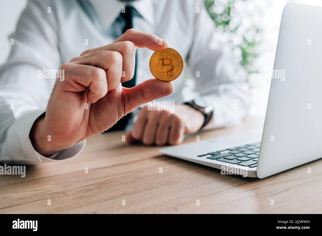 Bitcoin cryptocurrency investor concept, businessman offering one crypto currency coin, selective focus Stock Photo