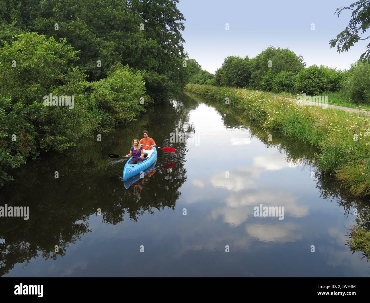 Netherlands, on a tributary from the Lek river, a couple is canoeing . Stock Photo