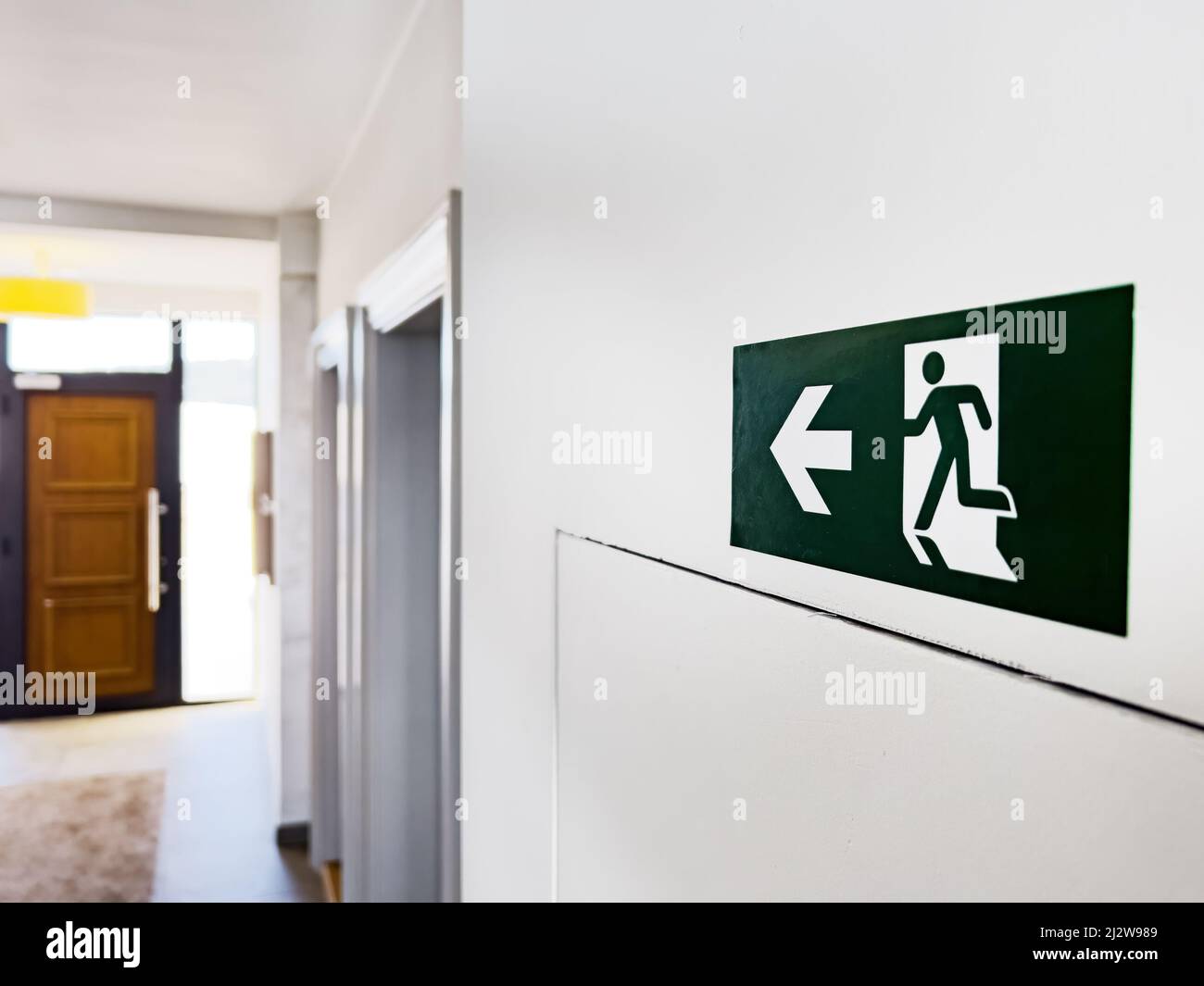 Fire exit sign in apartment building, selective focus Stock Photo