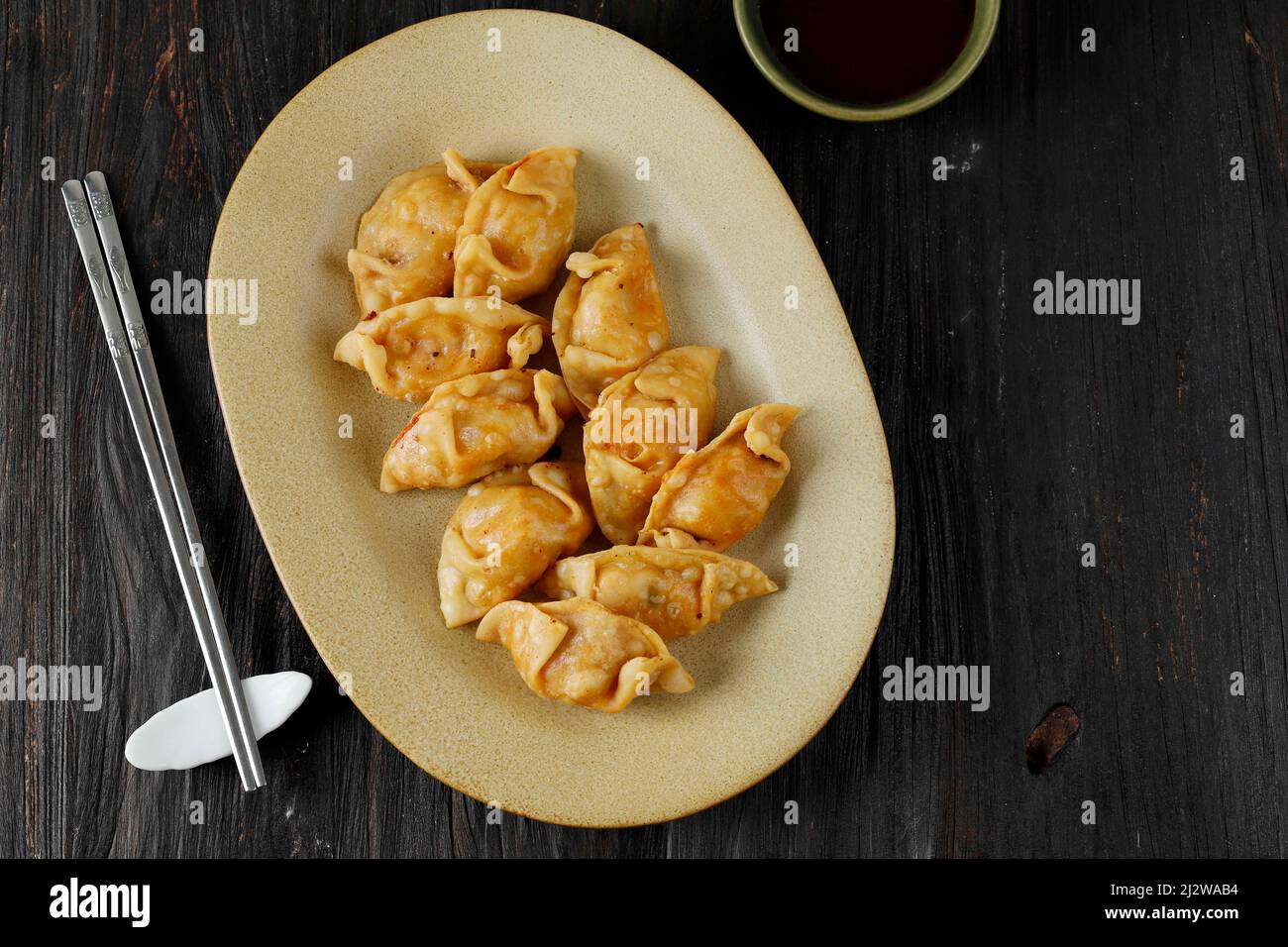 Fried Korean Kimchi Mandu Dumpling on Oval Plate, Top View Stock Photo