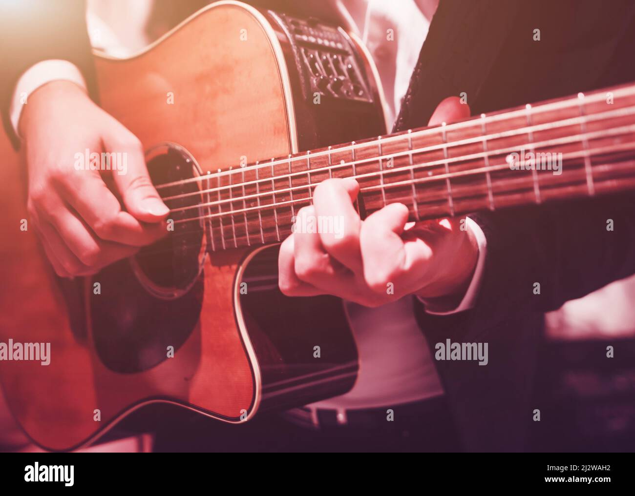 male hands playing the guitar. practice to play the instrument Stock Photo