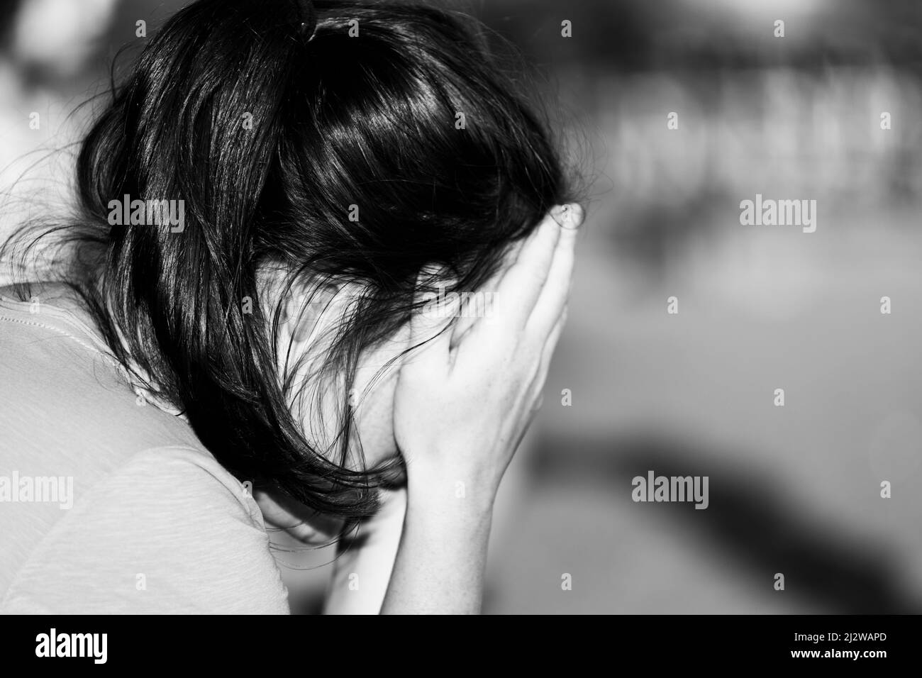 The woman covered her face with her hands. Black and white photo. High quality photo Stock Photo