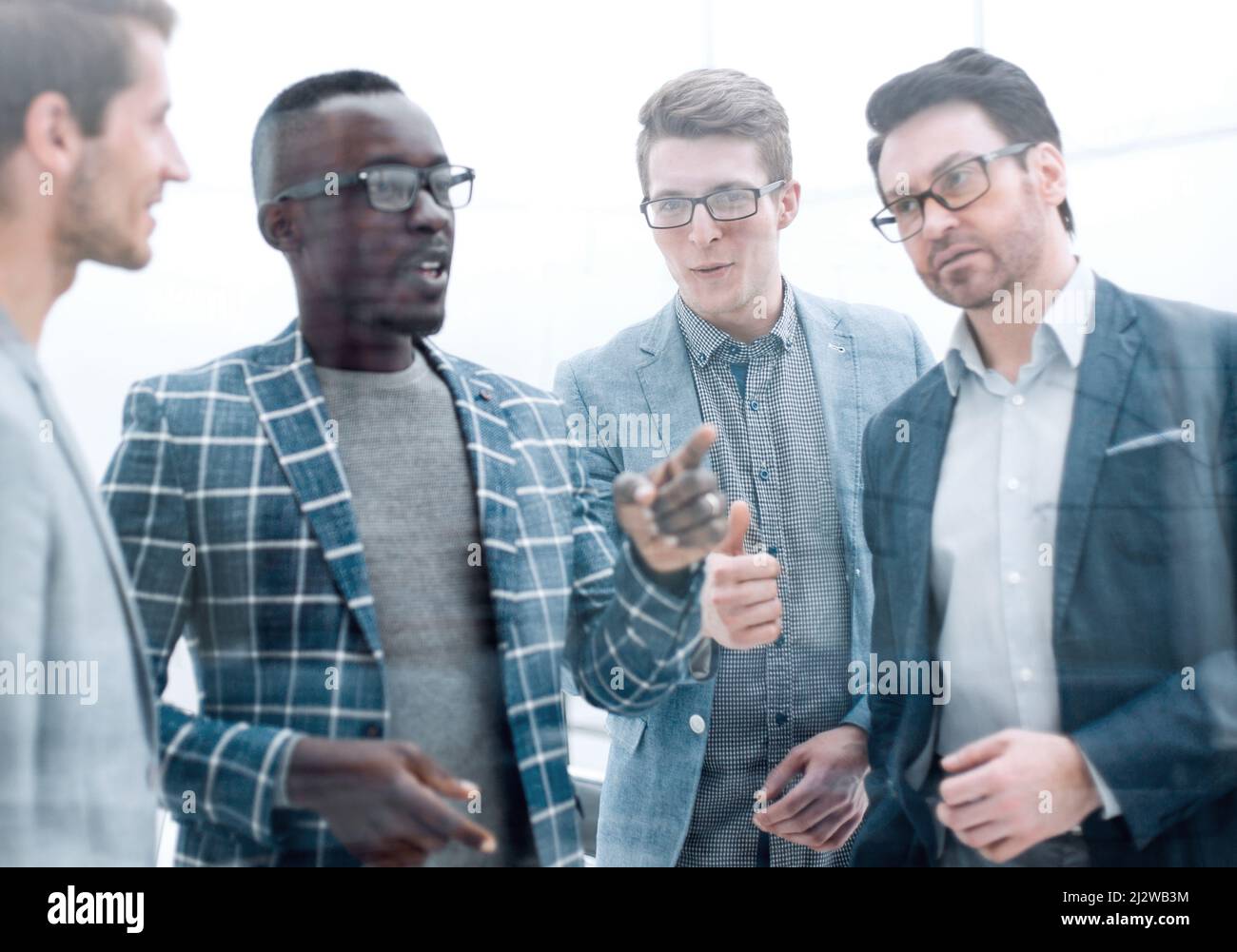 close up.business team talking standing in the office Stock Photo - Alamy