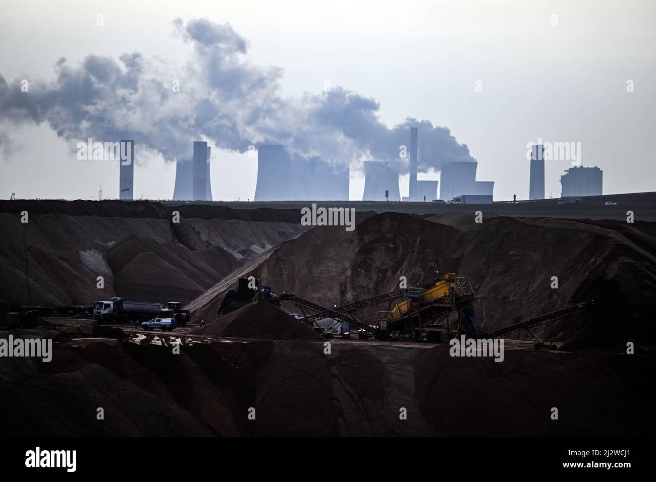 Jackerath, Germany. 04th Apr, 2022. Mining machines work in the Garzweiler open pit lignite mine, with the Neurath lignite-fired power plant in the background. Today, the Intergovernmental Panel on Climate Change intends to present a comprehensive overview of how man-made climate change can be limited. The report reflects the current state of research on what measures are necessary and effective to curb global warming and avert climate catastrophe. Credit: Federico Gambarini/dpa/Alamy Live News Stock Photo