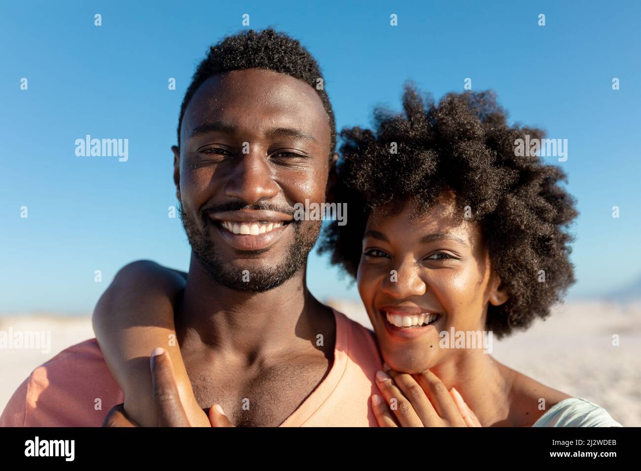 Portrait of happy african american couple enjoying summer holiday at beach Stock Photo
