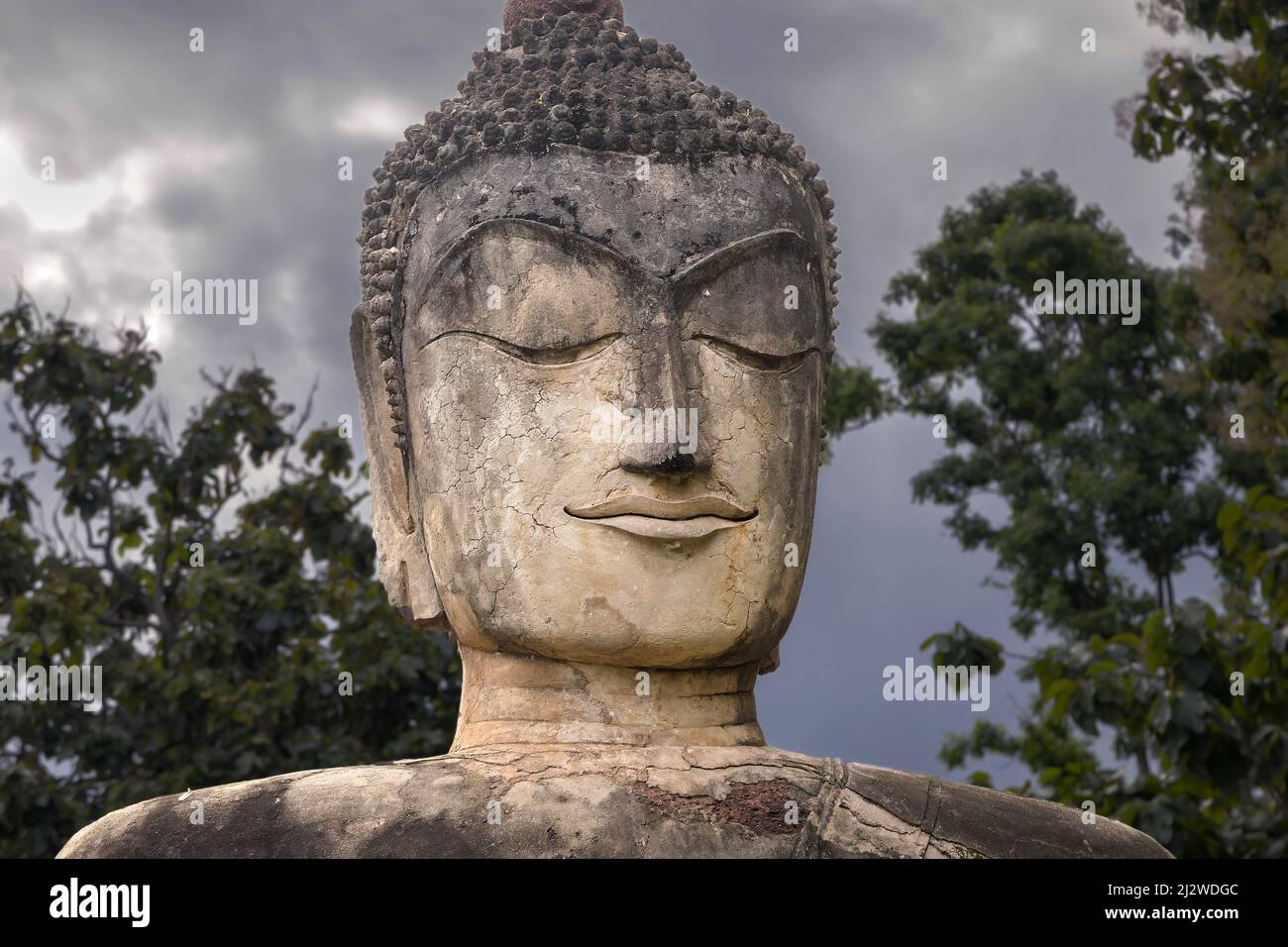 Seated Buddha Face at Wat Phra Kaeo, Kamphaeng Phet, Thailand. Stock Photo
