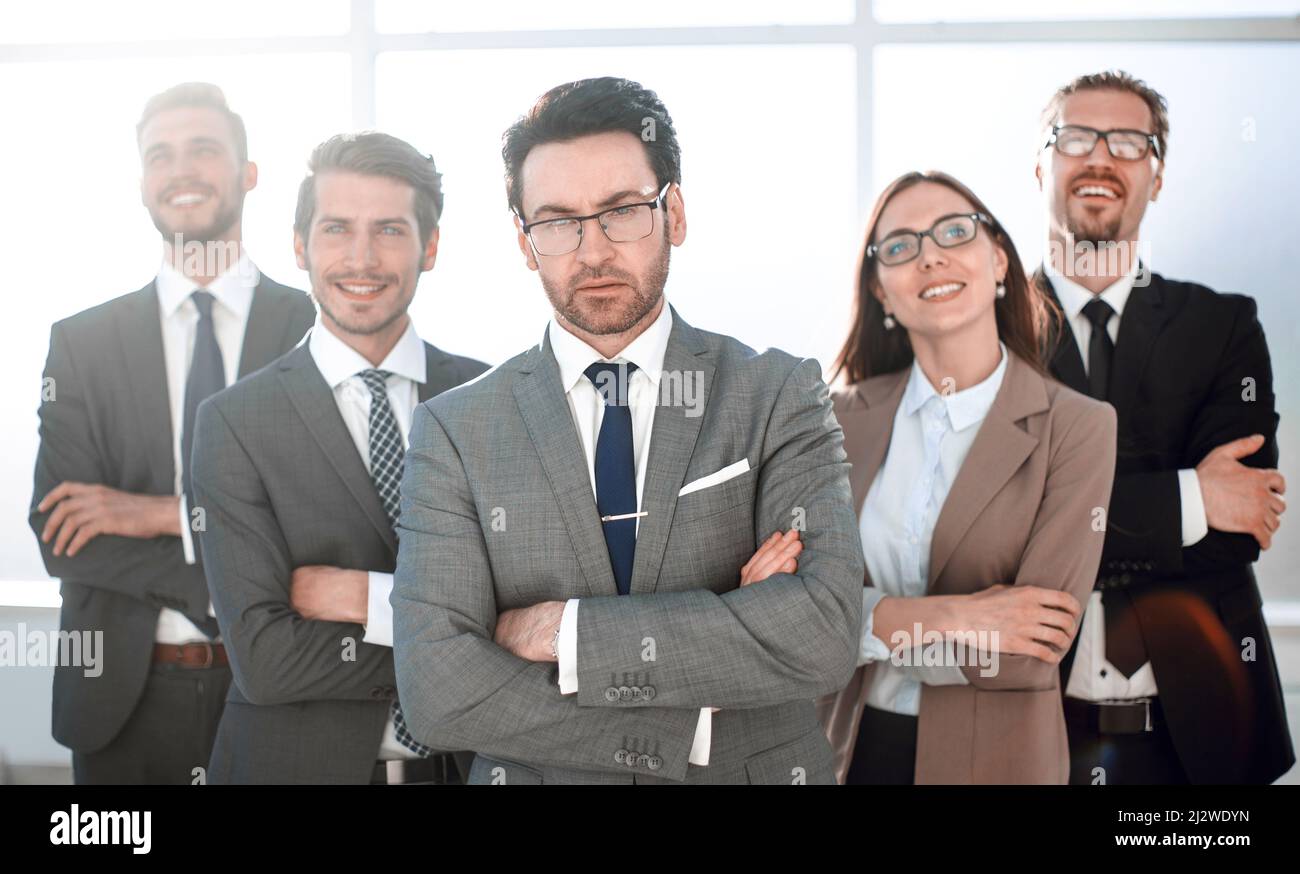 Happy business team with arms crossed at the office Stock Photo - Alamy