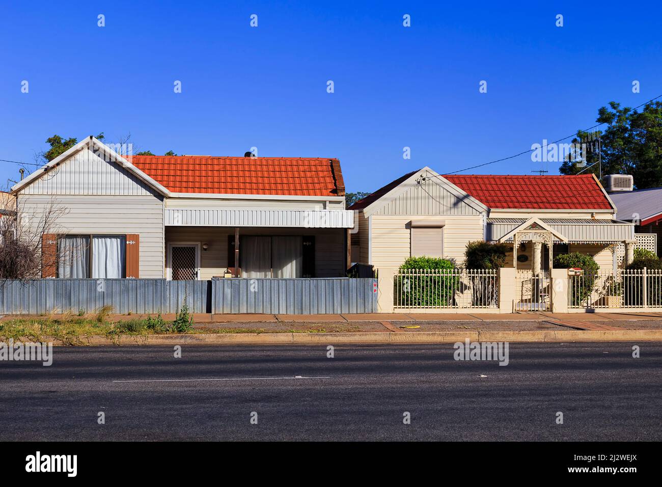 Small historic residential houses with red roofs in streets of Broken Hill city downtown - Australian outback. Stock Photo