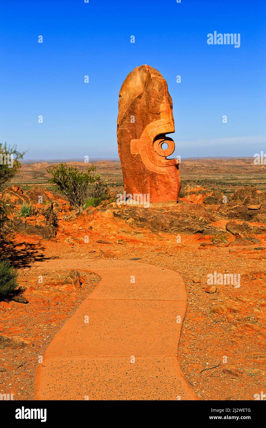 Stone sculpture in public sculpture garden at a pathway near Broken