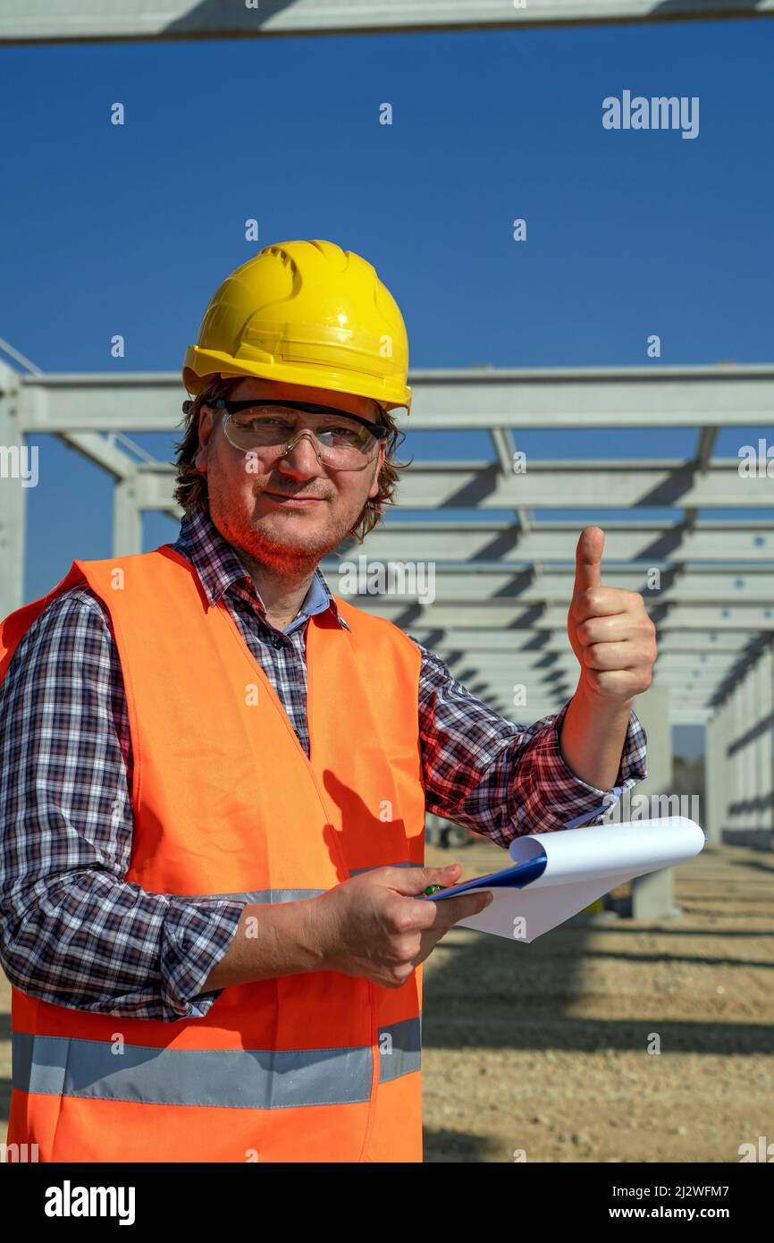 Construction Foreman Holding Clipboard and Looking at Camera. Worker in ...
