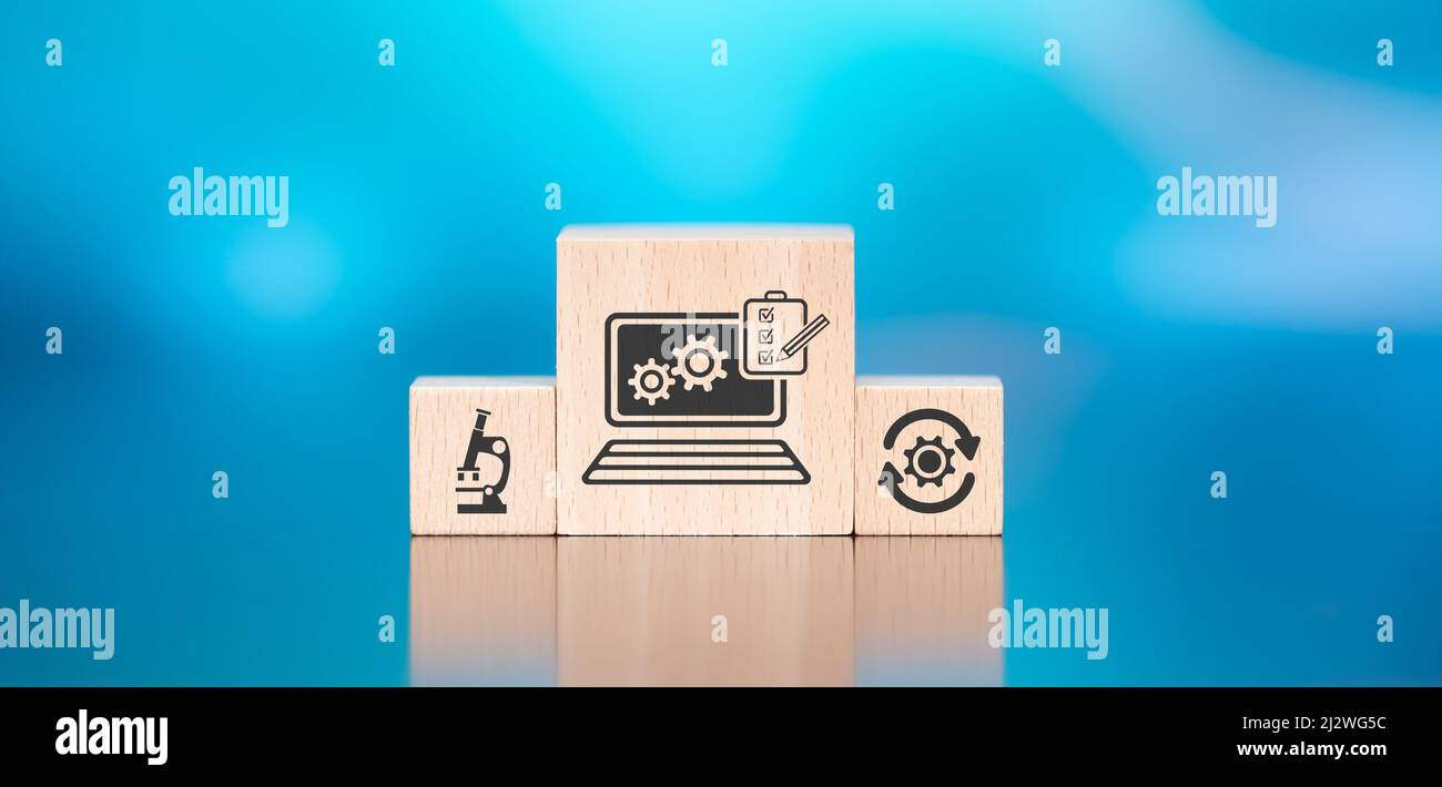 Wooden blocks with symbol of software testing concept on blue ...