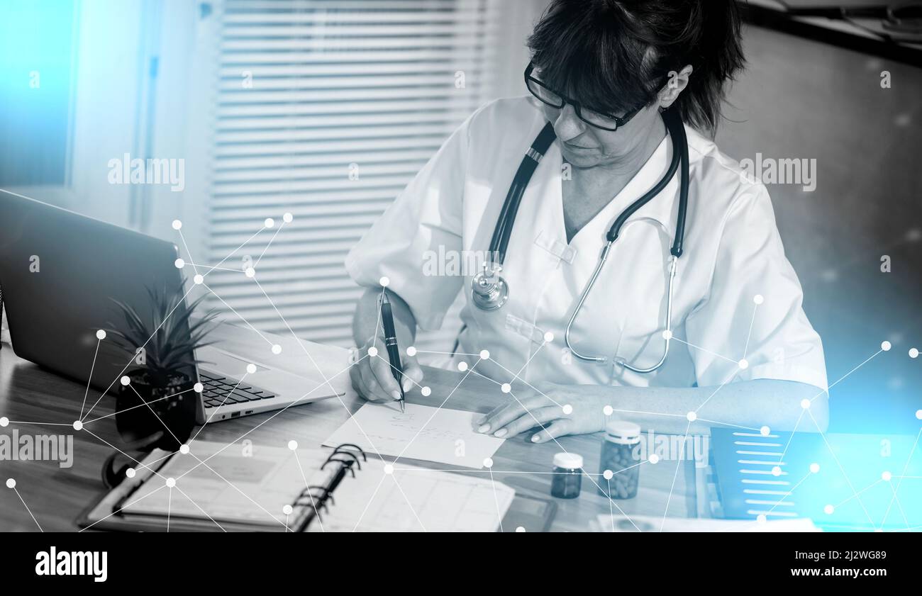 Female doctor writing prescription in medical office; light effect ...