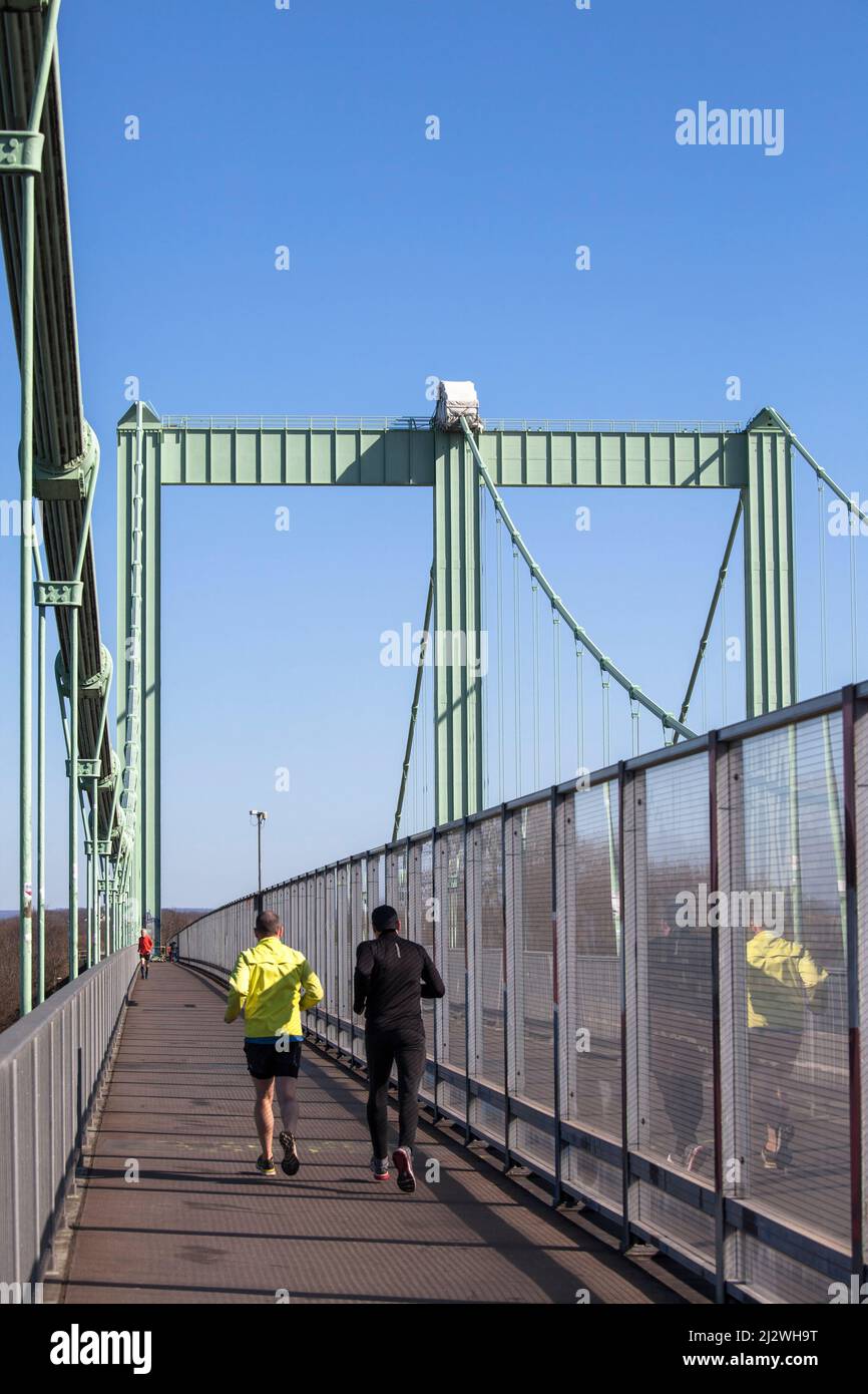 bike and foot path with sound protection wall on the Rodenkirchener bridge across the river Rhine, bridge of the Autobahn A4, Cologne, Germany. Rad- u Stock Photo