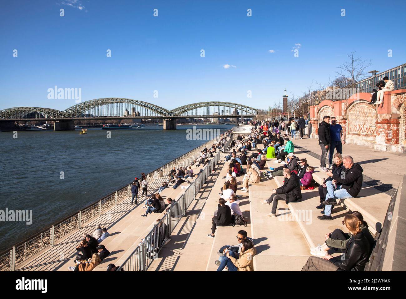people at the Rhine boulevard in the district Deutz, Hohenzollern bridge, Cologne, Germany. Menschen amr Rheinboulevard in Deutz, Hohenzollernbruecke, Stock Photo