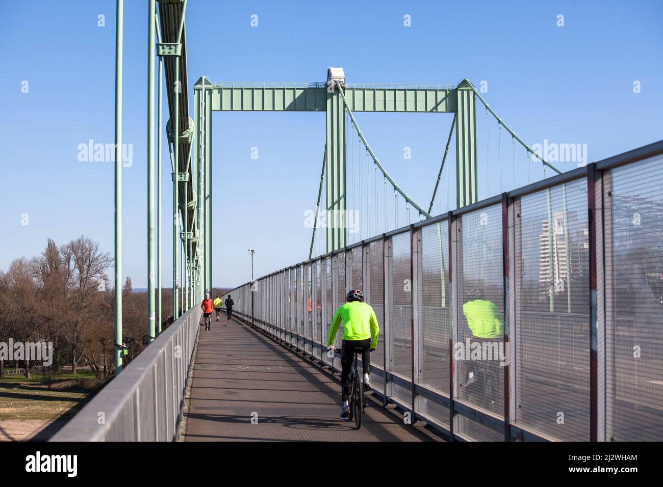 bike and foot path with sound protection wall on the Rodenkirchener bridge across the river Rhine, bridge of the Autobahn A4, Cologne, Germany. Rad- u Stock Photo