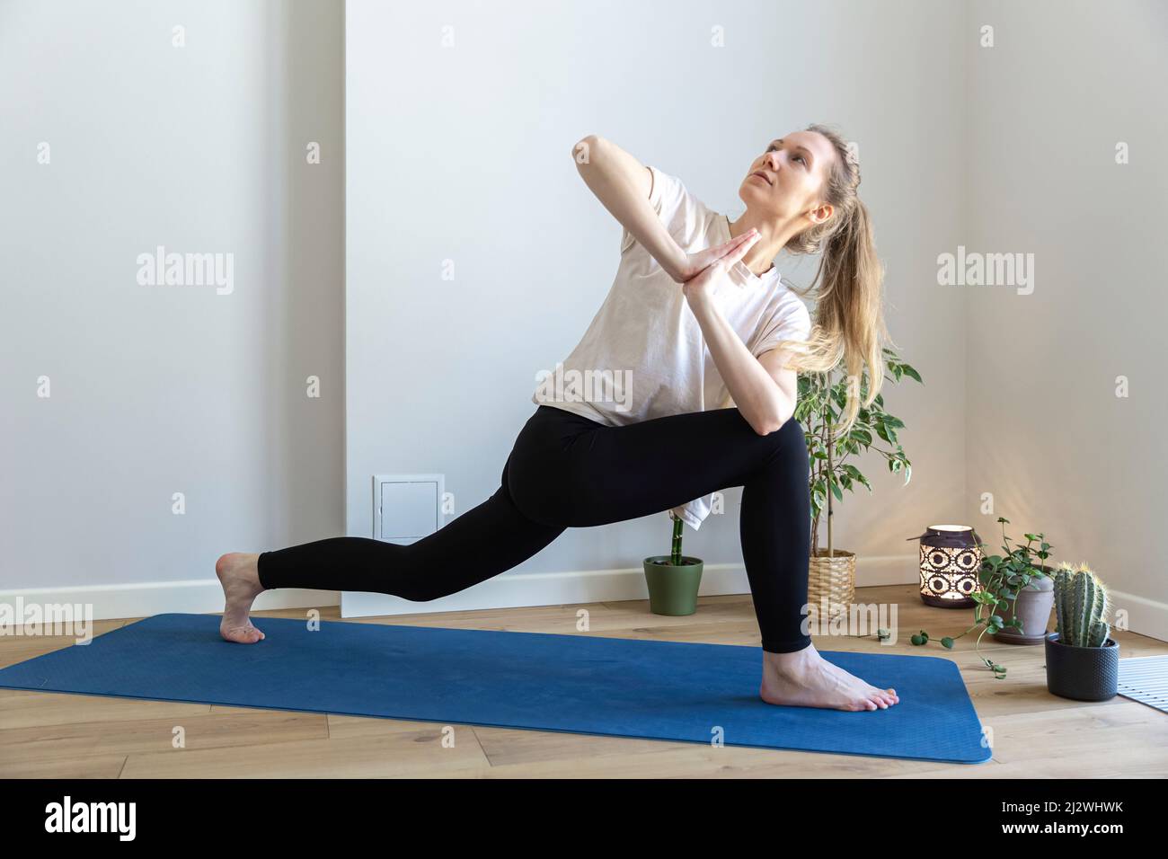 woman doing chest twisting pose Stock Photo