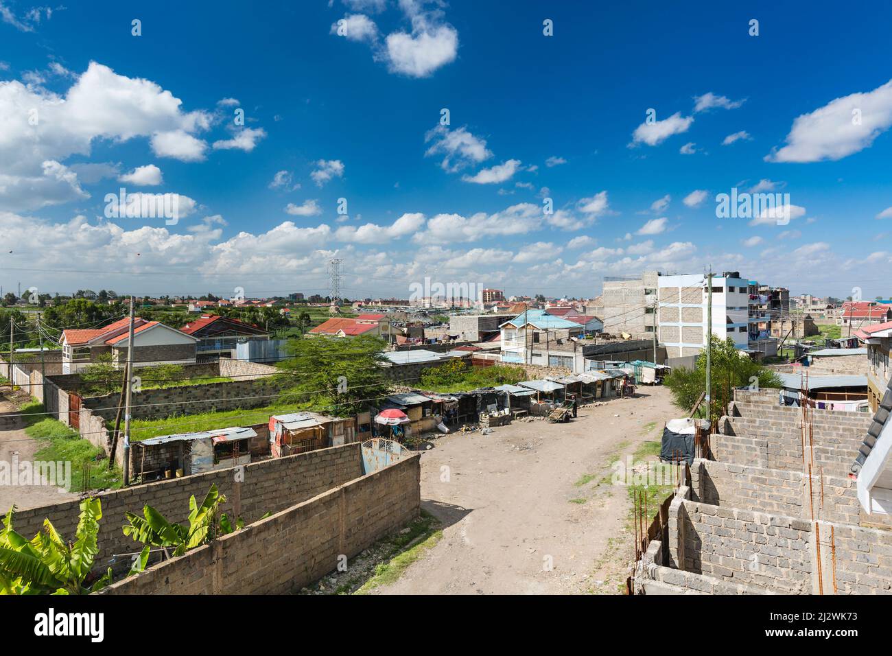 Nairobi suburbs street view in the Tassia district, Kenya with the typical small shops at the intersection. Stock Photo