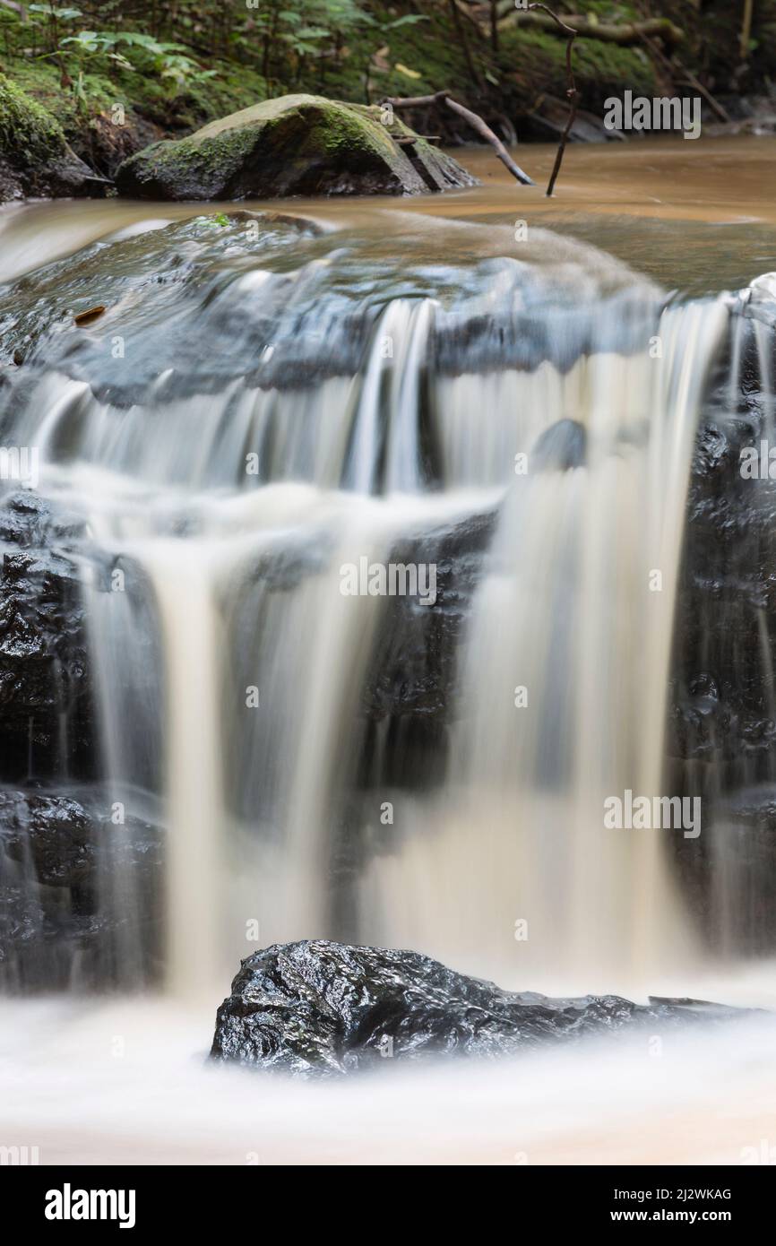 Long exposure detail shot of a small Nairobi River waterfall in Karura Forest, Kenya. Stock Photo