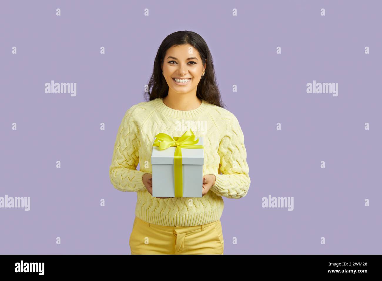 Smiling ethnic girl hold gift box in hands Stock Photo