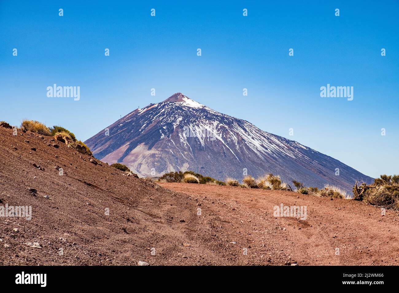 Teide National Park Tenerife with Volcano behind red gravel road Stock Photo