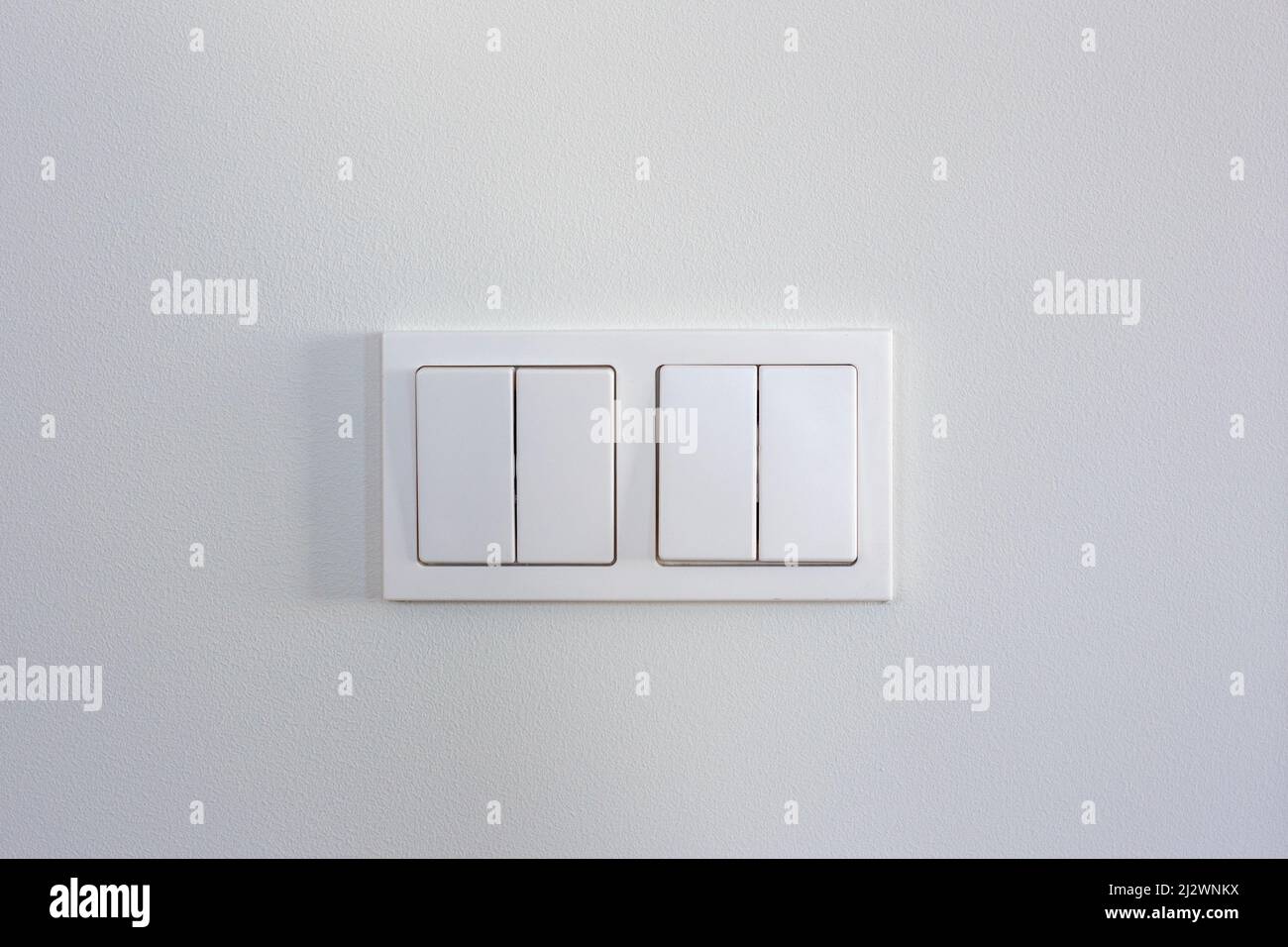 White light switches on a white wall Stock Photo Alamy