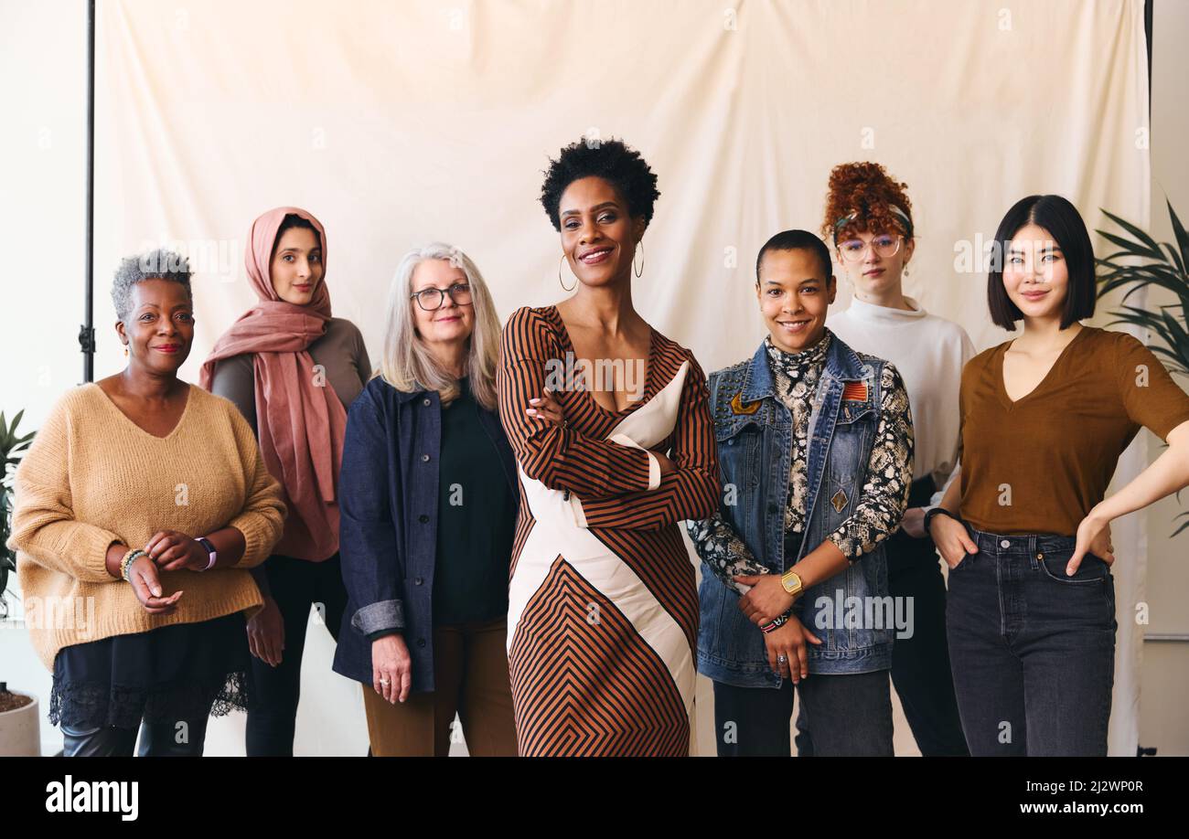 International Women's Day portrait of multiethnic mixed age range women looking confidently towards camera and smiling Stock Photo