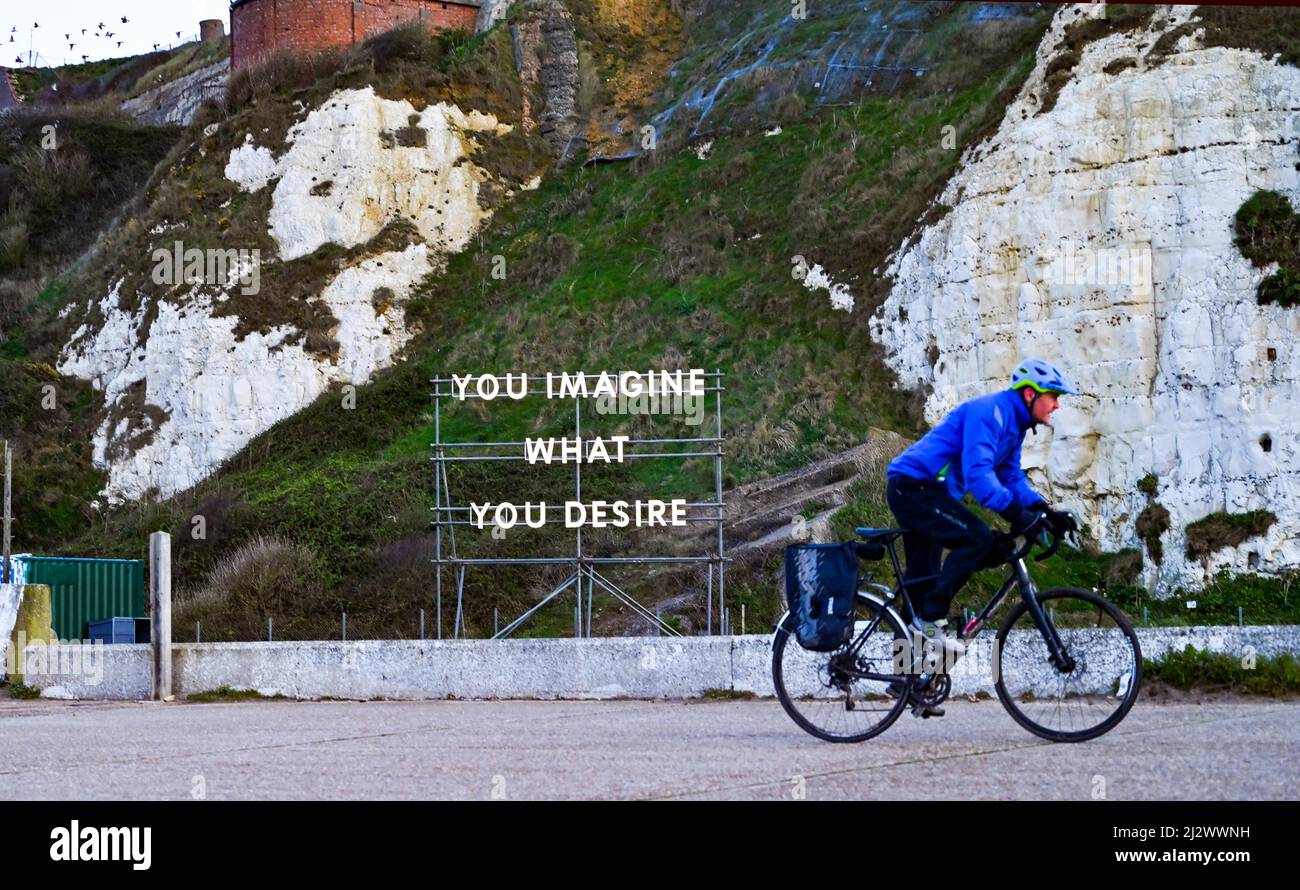 Newhaven UK 31st March 2022 - A cyclist passes by a light sculpture ...