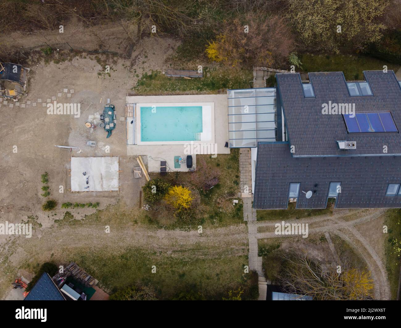 Drone shot of pool construction site with concrete pad for heat pump