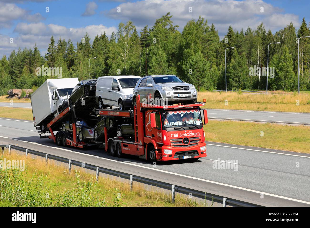 Red Mercedes-Benz Actros car carrier Oili Jalonen transports vehicles along motorway on a day of summer. Salo, Finland. July 10, 2020. Stock Photo