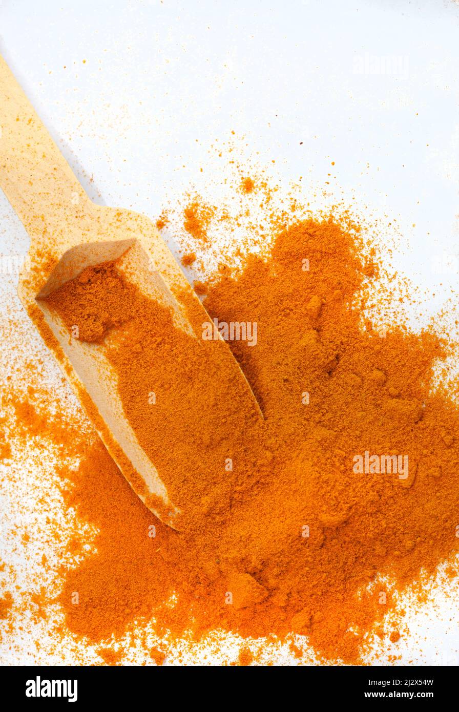 wooden scoop with fine organic ground Turmeric powder and copy space Stock Photo