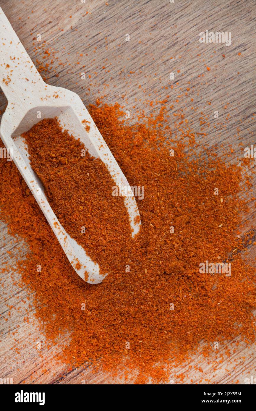 Cayenne pepper powder with wooden scoop and copy space Stock Photo