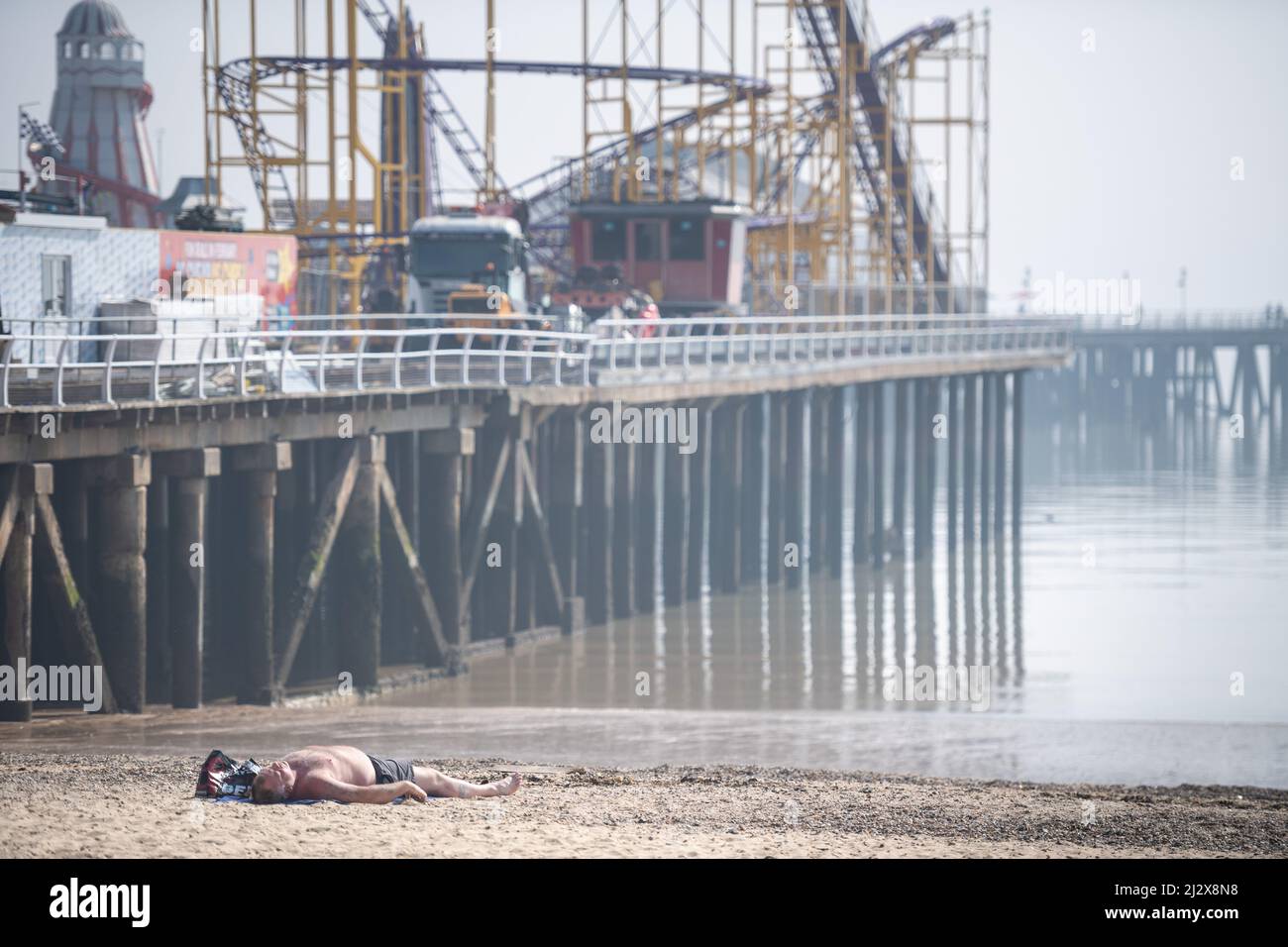 Clacton-on-Sea, Essex, UK. 24th March 2022. Sun worshippers take to the beach at Clacton-on-Sea on what could be one of the warmest days of the year s Stock Photo