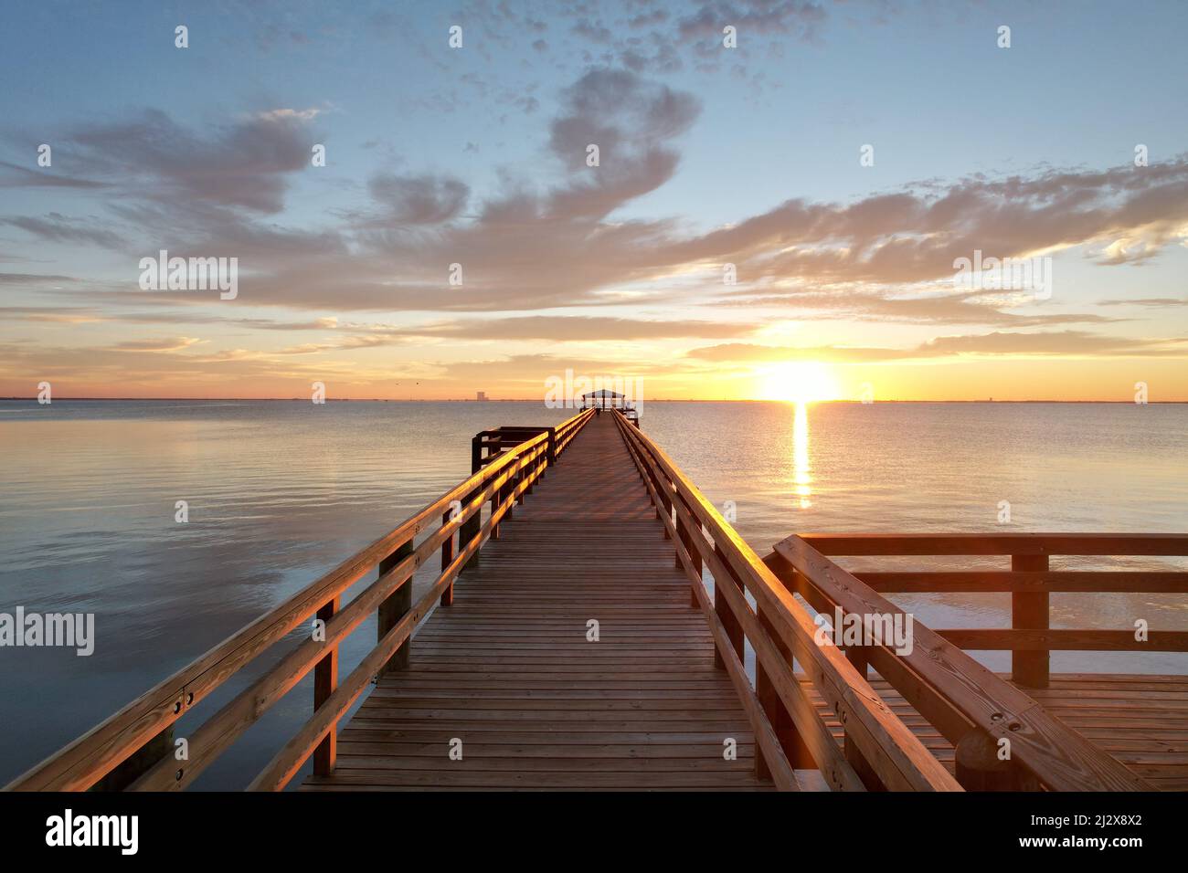 A scenic view of a wooden pier over the body of water in Rotary