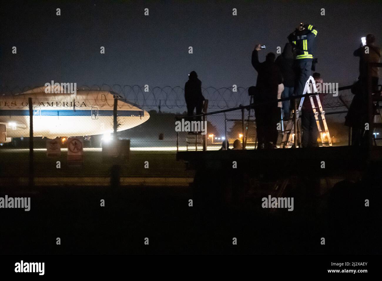 RAF Mildenhall, Suffolk, UK. 26th March 2022. Plane spotters watch as the US Air Force 'Doomsday' plane prepares to take off from RAF Mildenhall in Su Stock Photo