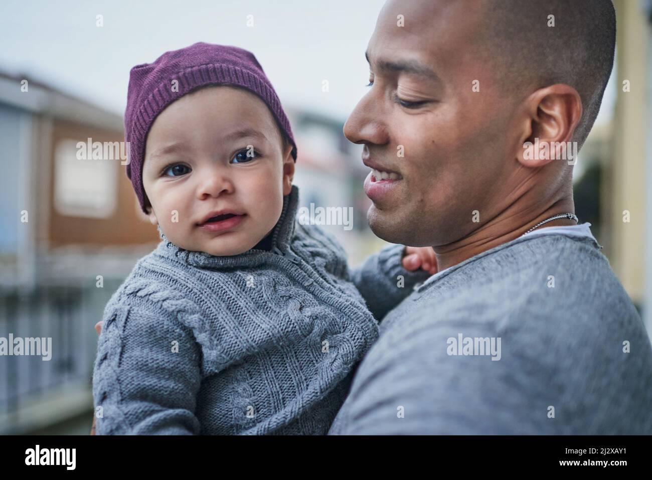 That cute smile gets me every time. Shot of a father bonding with his little son outdoors. Stock Photo