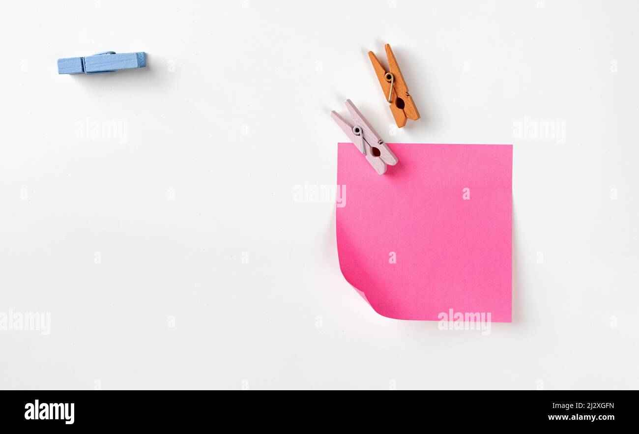 Clothespins and sticker on white Stock Photo