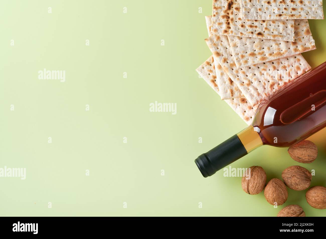 Passover celebration concept. Matzah, red kosher wine and walnut