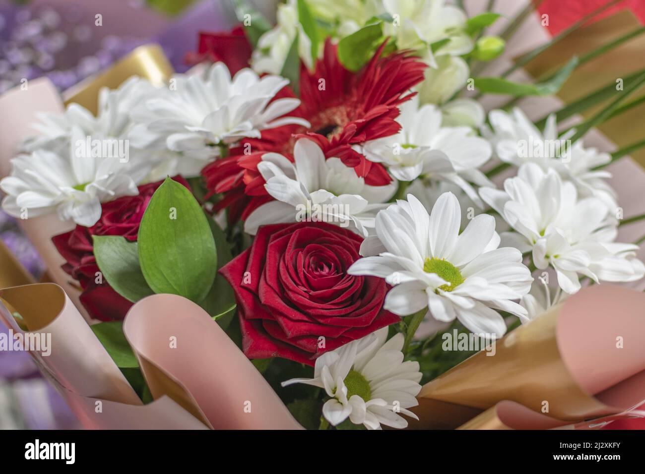 Beautiful flower bouquet of white daisies and red roses. A beautiful ...