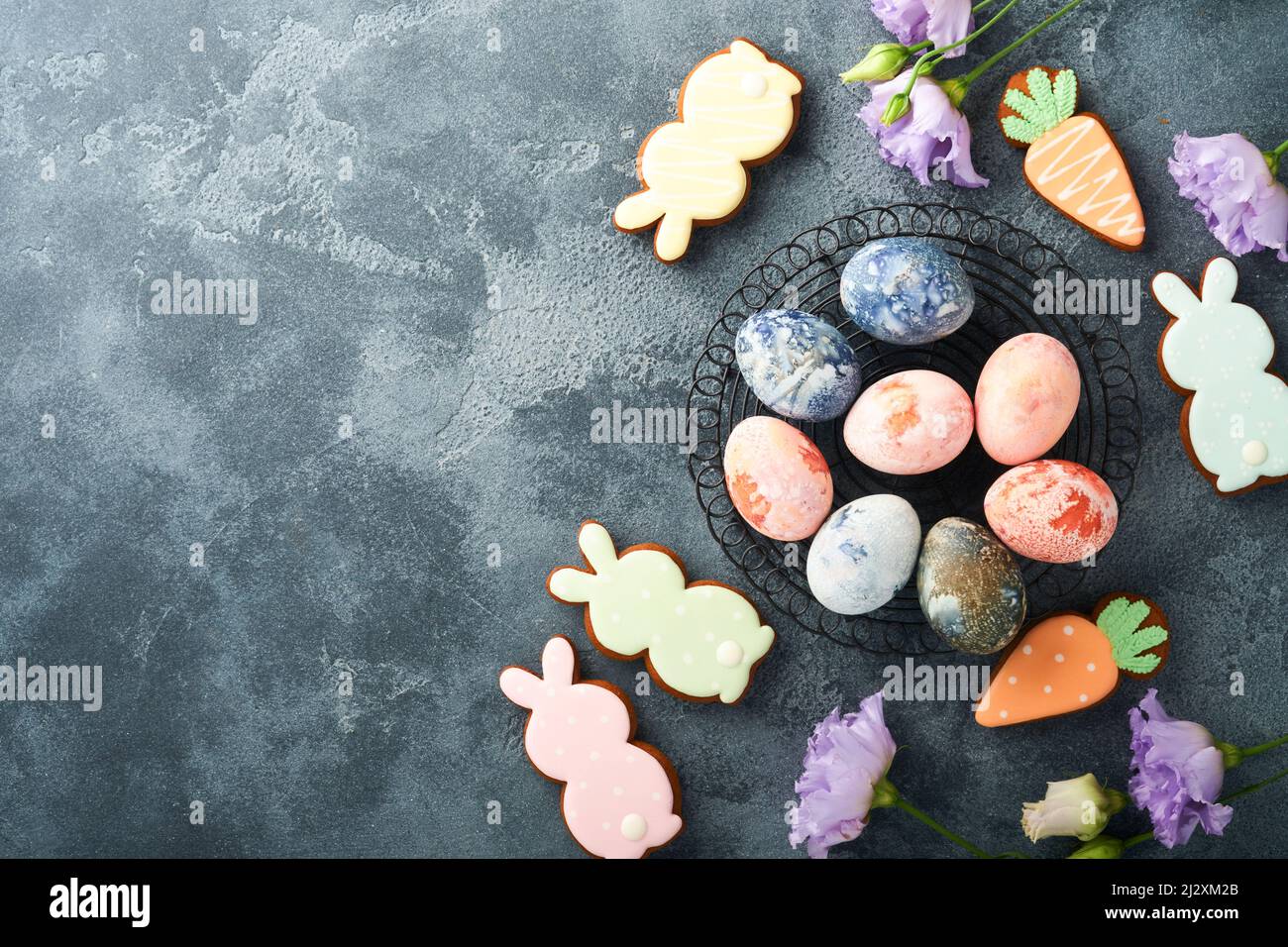 Easter eggs. Dyed Easter eggs with marble stone effect ref and blue color in rustic style on dark stone background. Easter background. Top view. Stock Photo