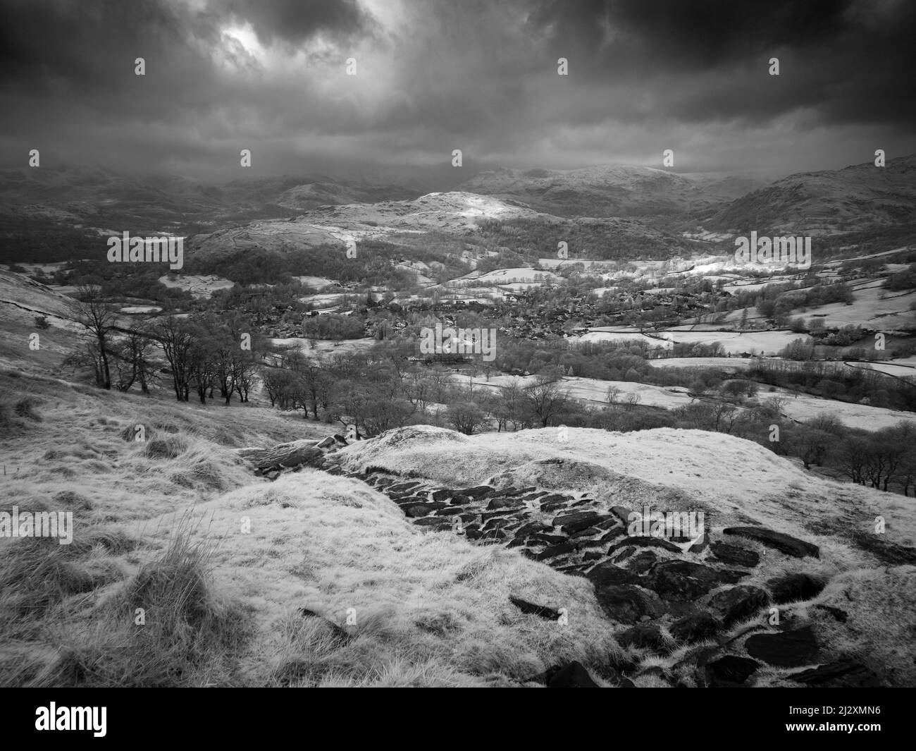 A black and white image of Ambleside, and Loughrigg Fell from Wansfell in the Lake District National Park, Cumbria, England. Stock Photo